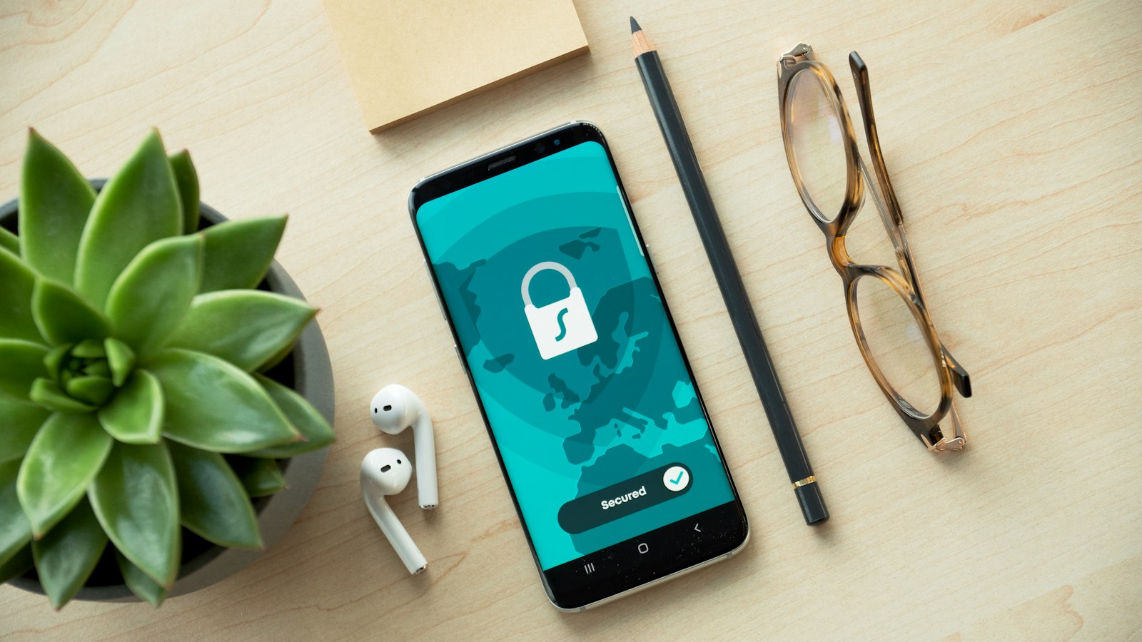 A smartphone showing a lock icon on a wooden desk